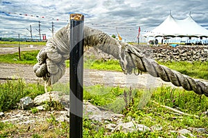 Old mooring rope hanging on a black pole photo