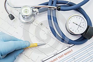 The scene with the work of cardiologist or general practitioner. The physician indicates to the patient pathological ECG which lie