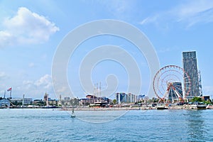 Scenery of Batumi Seaport and Beach of the Black Sea with Red Ferris Wheel