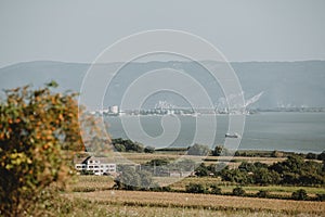 The scenery with big cargo ship is incoming to the industry harbour on the Danube river on the serbia romanian border