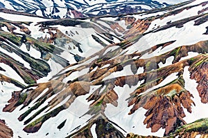 Scenery of Blahnjukur trail with volcanic mountain and snow covered in Fjallabak nature reserve on Icelandic highlands at