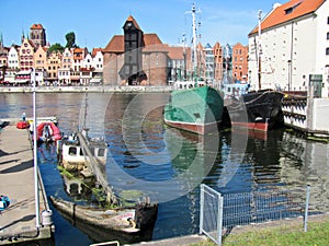 Scenery with boats of Gdansk old town in Poland, port crane Zuraw and Motlawa River