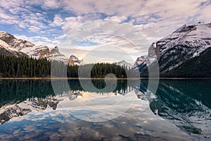 Scenery of Canadian rockies with pine forest reflection on Maligne lake in Jasper national park