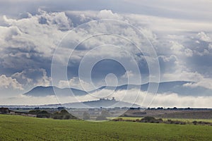 Scenery of cereals fields and little town with castle between th