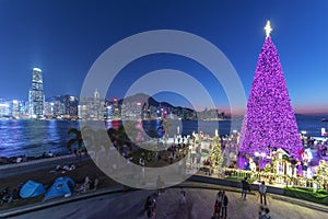 Scenery of Christmas tree and decoration with skyline of Victoria harbor of Hong Kong city