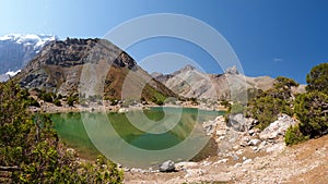 Scenery Fann mountains in Tajikistan. Wild mountain nature with lake on clear day. Beautiful Kulikalon lake in Fan mountains.