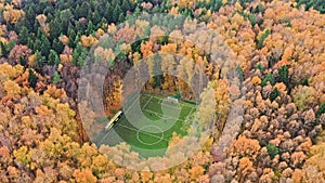 scenery football stadium hidden in autumn forest