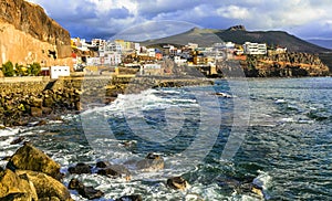 Scenery of Gran Canaria - Puerto de Sardina coastal town over sunset. Canary islands photo