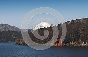 The scenery of Hakone Lake or Ashinoko Lake with red torii gate and Mount Fuji-sang at the background.