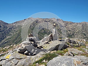 Scenery of high mountainn peaks in corsician alpes with green bu