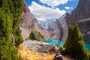 Scenery mountains with blue lake on sunny summer day. Mountain landscape in Greater Allo lake in Fann mountains, Tajikistan, Pamir