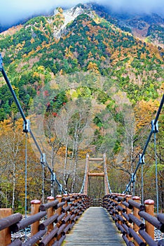 Scenery of Myojin bridge in late autumn at Kamikochi National Park, Matsumoto, Nagano, Japan