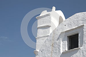 Scenery of the old church bell tower touching the sky in the Greek island of Folegandros