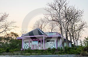 Scenery of a pink and white old concrete house abandoned mysteriously