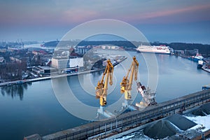 Scenery of port cranes by the Martwa Wisla river at sunset, Gdansk. Poland