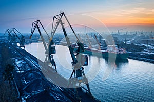 Scenery of port cranes by the Martwa Wisla river at sunset, Gdansk. Poland