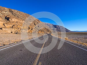 Scenery route through Death Valley National Park - lonesome road in the desert