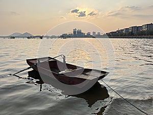 Scenery with Small fishing boat in lakes and Sunset