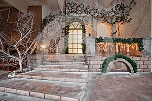 The scenery of the Studio or theater. Entrance in an old architecture with staircase and columns. Christmas decoration