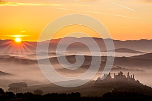Scenery sunrise in misty Tuscany, Italy