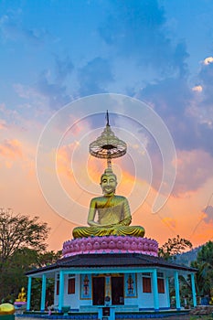 Scenery sunset behind the golden buddha in Chiang Rai