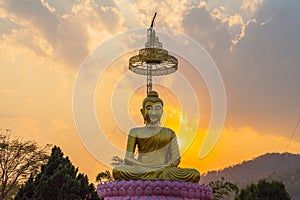 scenery sunset behind the golden buddha in Chiang Rai