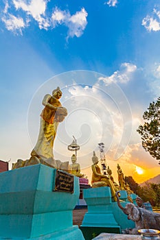 Scenery sunset behind the golden buddha in Chiang Rai