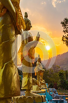 Scenery sunset behind the golden buddha in Chiang Rai