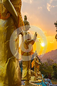 Scenery sunset behind the golden buddha in Chiang Rai