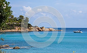 Scenery view Italian island Sardinia sea shore beach rock coast and anchored boat in Arbatax sardegna