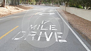 Scenic 17-mile drive, Monterey, California coast. Sign on asphalt, road marking.