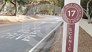 Scenic 17-mile drive, Monterey, California coast. Sign on asphalt, road marking.