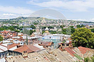 Scenic aerial beautiful view panorama of old historic city Tbilisi center, architecture buildings roofs, Georgia in summer sunny