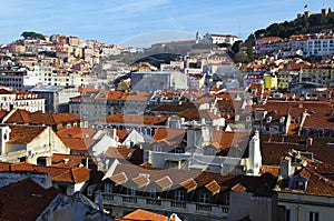 Scenic aerial landscape of city center of Lisbon. View from top of Santa Justa Lift. Vintage buildings with red tile roofs.