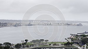 Scenic aerial San Diego bay view on a heavily overcast day with Navi ship visible in the background, California