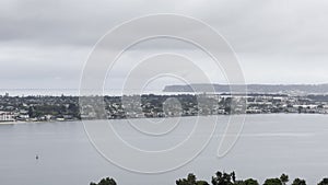 Scenic aerial San Diego bay view on a heavily overcast day with Navi ship visible in the background, California