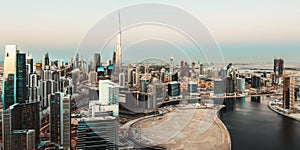 Scenic aerial skyline: Dubai`s business bay with modern skyscrapers at sunset