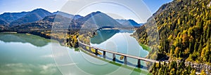 Scenic aerial view of the bridge over Lake Sylvenstein with beautiful reflections. Alps Karwendel Mountains in the back