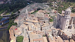 Scenic aerial view of Catalan city of Girona on river Onyar with Cathedral and Collegiate Church on summer day, Spain