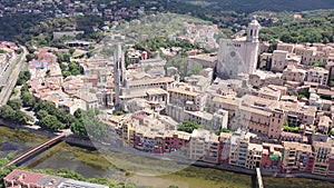 Scenic aerial view of Catalan city of Girona on river Onyar with Cathedral and Collegiate Church on summer day, Spain