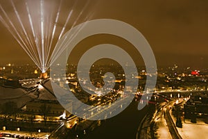 Scenic aerial view of Gediminas tower in Vilnius Old Town beautifully illuminated for 700th birthday celebration. Main symbol of