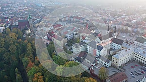 Scenic aerial view of historical centre of Jihlava in autumn gauze overlooking belfries of St. James and St. Ignatius