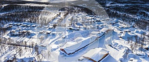 Scenic aerial view on snow covered Swedish Norwegian camping in Tarna Vilt village in Lapland, close to state border, Joesjo,