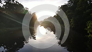 Scenic aerial view of tropical rainforest jungle river at sunrise close to the water