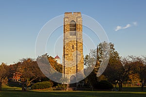 Scenic autumn image of the Joseph D. Baker Tower and Carillon at sunset located in Baker Park, Frederick.