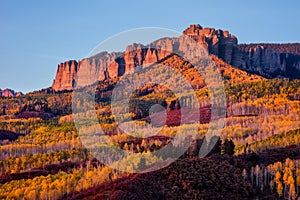 Scenic autumn landscape with aspen trees beneath Cimarron Ridge, Colorado