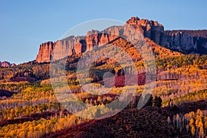 Scenic autumn landscape with aspen trees beneath Cimarron Ridge, Colorado photo