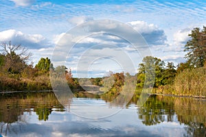 Scenic autumn landscape in European Russia. Calm river with sky and trees reflection. Photo wallpaper background