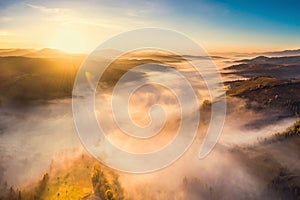 Scenic autumn landscape with fog in mountains