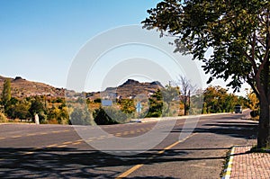 Scenic autumn landscape view of asphalt road in Cappadocia. Amazing shaped sandstone rocks against blue sky